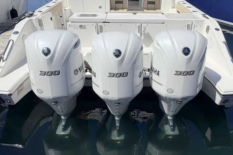Slide: The Image of Triple Yamaha 300 engines on a 2020 Pursuit OS 355 Offshore boat. - 30