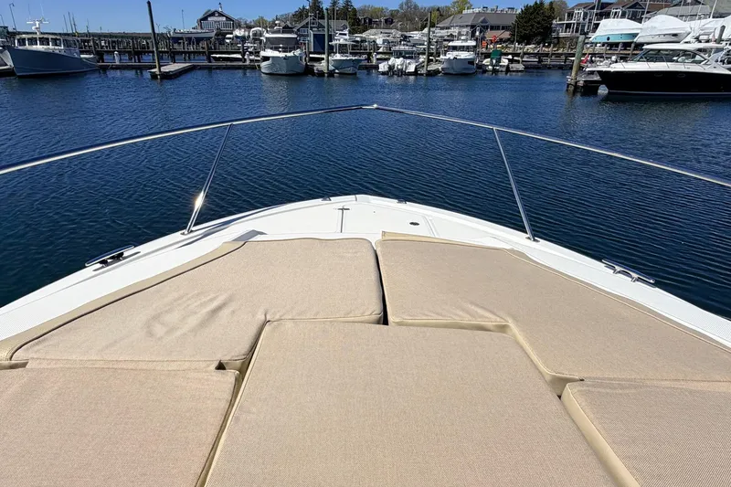 Slide: The Image of 2020 Pursuit OS 355 Offshore boat with sun pads, docked in a marina. - 4