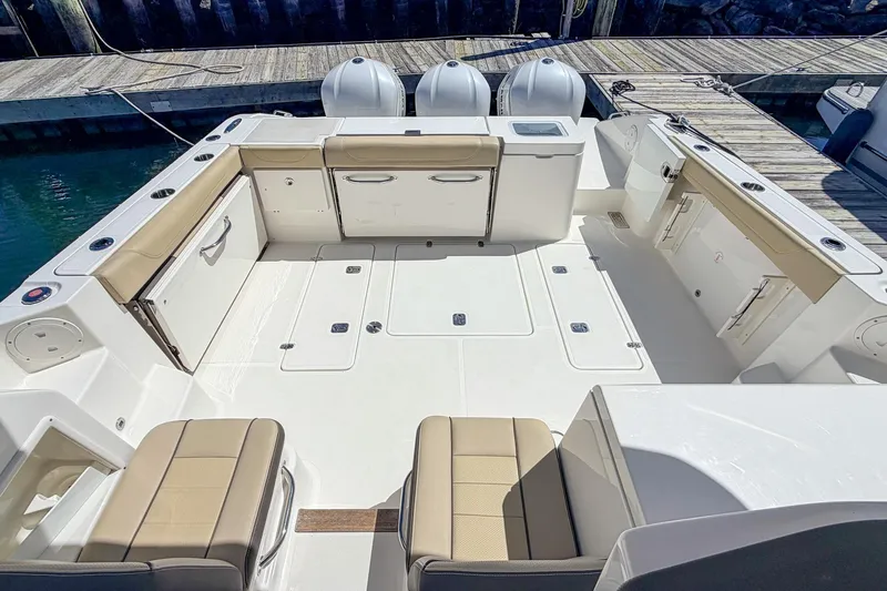 Slide: The Image of 2020 Pursuit OS 355 Offshore boat deck with seating and storage compartments. - 5