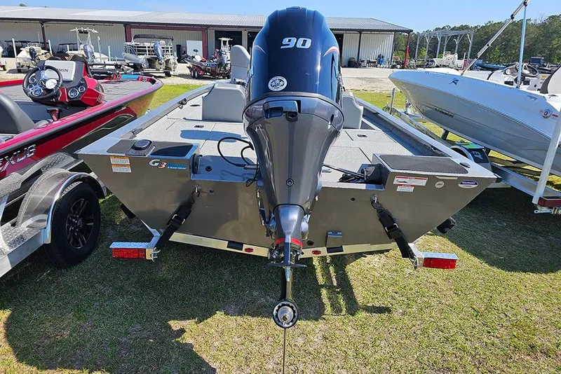 Slide: The Image of 2026 G3 Sportsman 1710 boat with powerful outboard motor, parked on grass. - 9