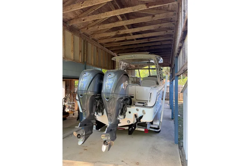 The Image of 2023 Grady-White Freedom 285 boat with dual Yamaha 300 engines in a covered dock. - 0