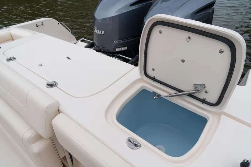 Slide: The Image of Manufacturer Provided Image: 2023 Grady-White Freedom 285 boat with open storage compartment and outboard motor. - 11