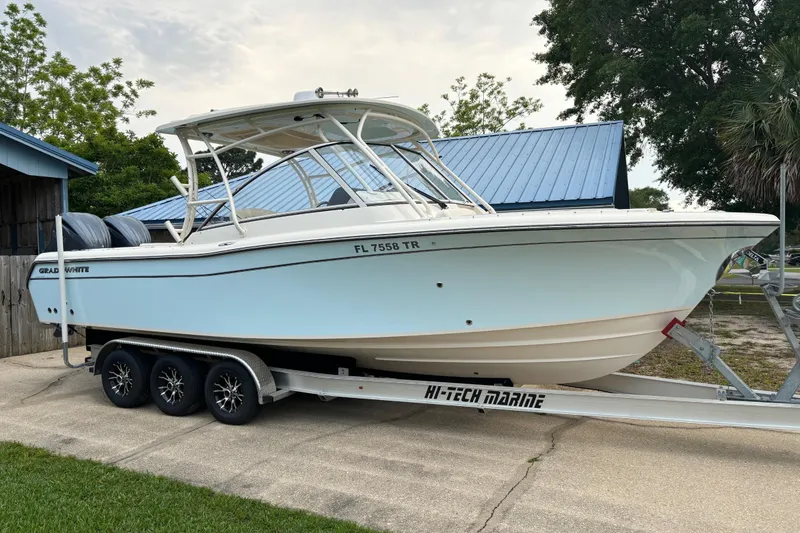 Slide: The Image of 2023 Grady-White Freedom 285 boat on trailer, parked outdoors. - 2