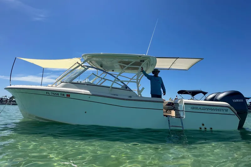 Slide: The Image of 2023 Grady-White Freedom 285 boat on clear water under blue sky. - 3