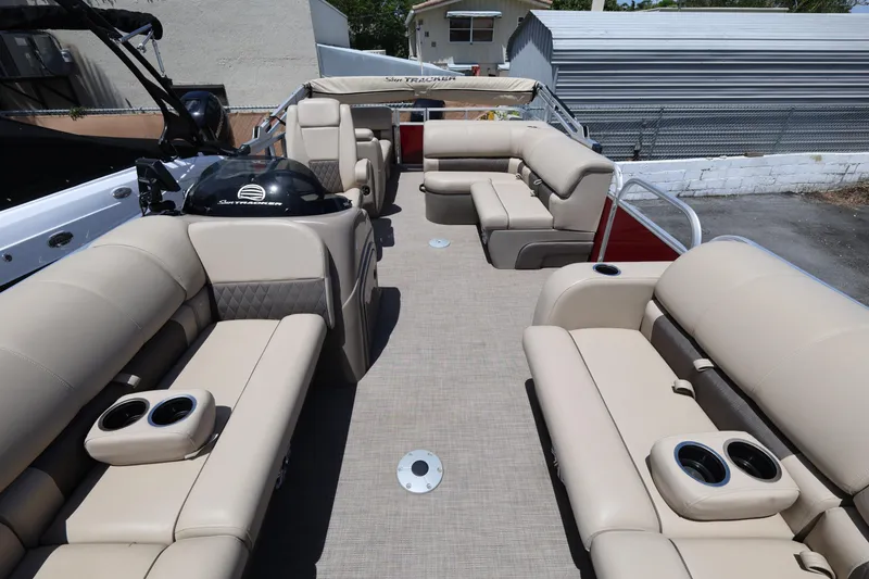 Slide: The Image of 2023 SUNTRACKER PB 22DLX pontoon boat with spacious seating and cup holders. - 14