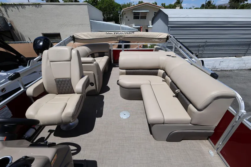 Slide: The Image of 2023 SUNTRACKER PB 22DLX pontoon boat with beige seating and spacious interior. - 15