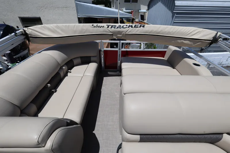Slide: The Image of 2023 SUNTRACKER PB 22DLX pontoon boat with beige seating and canopy. - 16