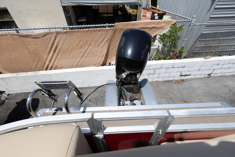 Slide: The Image of 2023 SUNTRACKER PB 22DLX pontoon boat with outboard motor and ladder. - 17