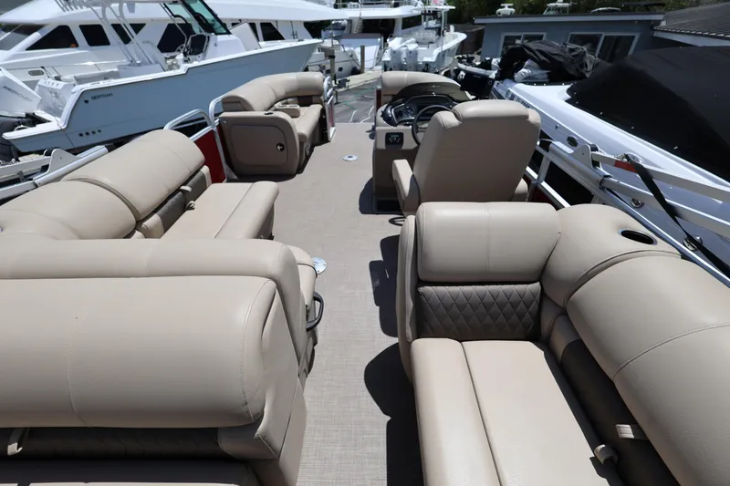 Slide: The Image of 2023 SUNTRACKER PB 22DLX pontoon boat with beige seating and spacious deck layout. - 20
