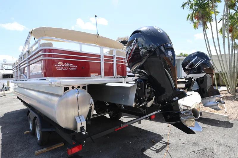 Slide: The Image of 2023 SUNTRACKER PB 22DLX pontoon boat with dual Mercury engines on trailer. - 6