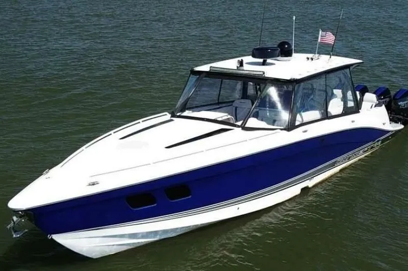 Slide: The Image of 2020 Concept 44' Cuddy Cabin boat on water, featuring sleek blue and white design. - 4