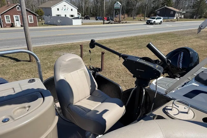 Slide: The Image of 2013 Premier 221 Explorer boat interior with beige seating and Mercury motor. - 10