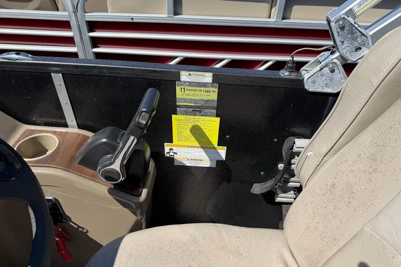 Slide: The Image of Interior of a 2013 Premier 221 Explorer boat showing control panel and seating. - 13