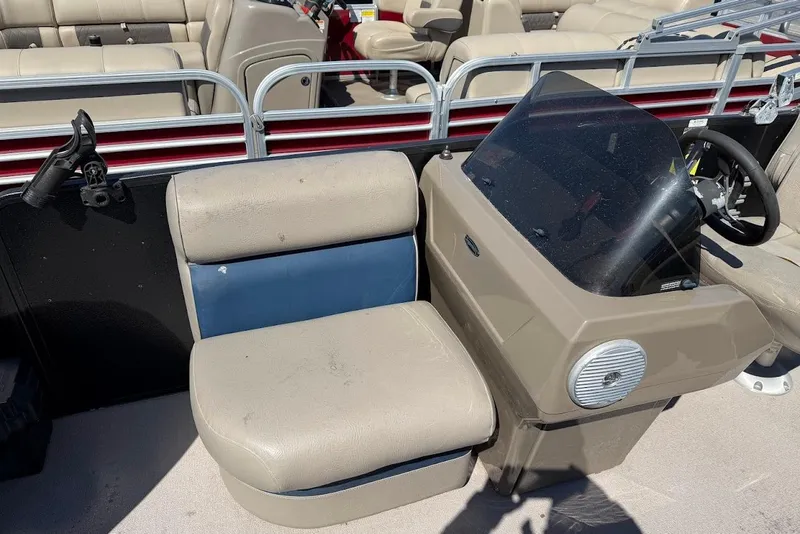 Slide: The Image of 2013 Premier 221 Explorer boat interior with beige seating and steering console. - 4