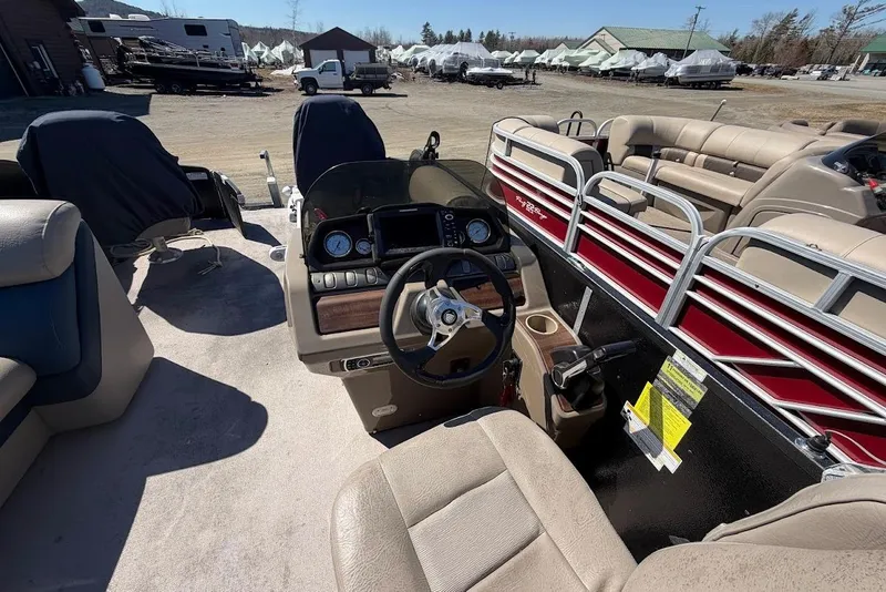 Slide: The Image of Interior of a 2013 Premier 221 Explorer pontoon boat with beige seating and control panel. - 5