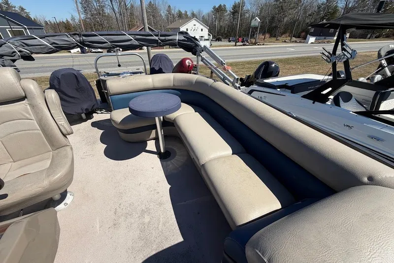 Slide: The Image of 2013 Premier 221 Explorer boat interior with beige seating and small round table. - 6