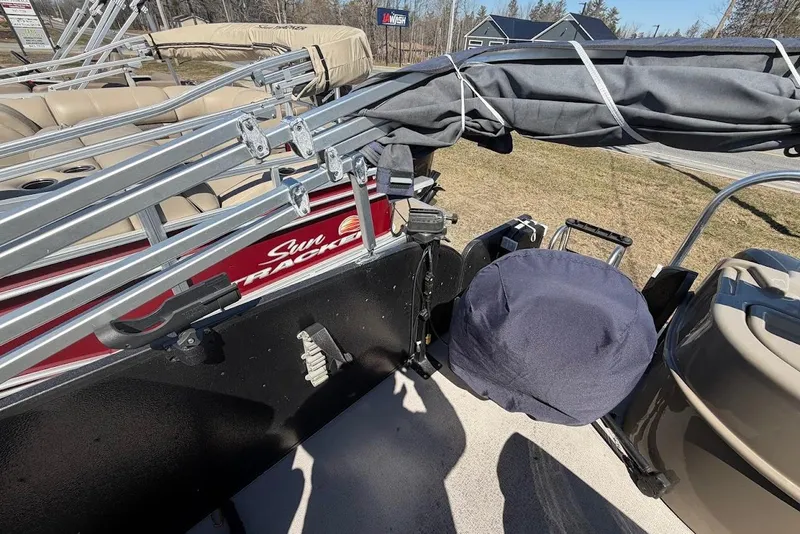 Slide: The Image of Pontoon boat with folded canopy, Premier 221 Explorer, 2013 model, parked on grass. - 7