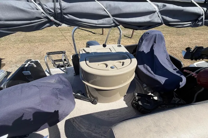 Slide: The Image of 2013 Premier 221 Explorer boat interior with covered seats and helm station. - 8