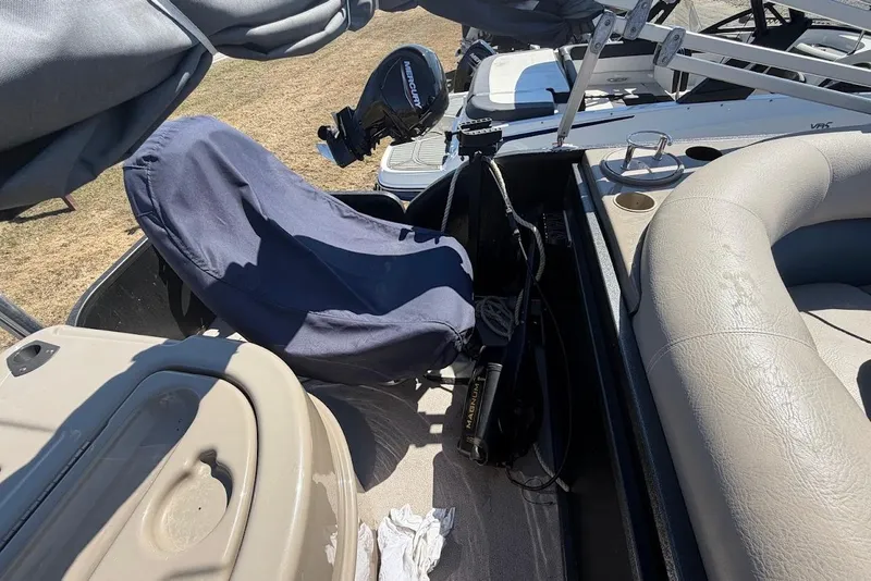 Slide: The Image of Interior of a 2013 Premier 221 Explorer boat with covered seating and equipment. - 9