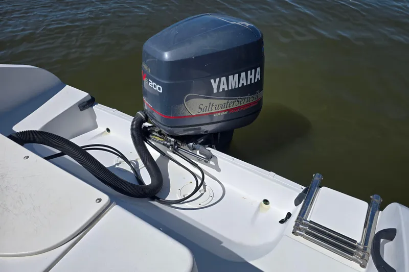 Slide: The Image of 2003 Seaswirl Striper 2301 Walkaround OB with Yamaha outboard motor on water. - 10