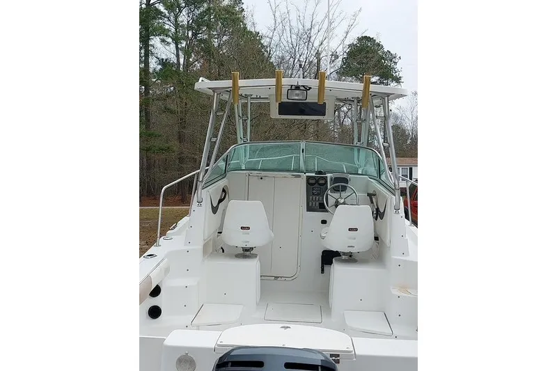 Slide: The Image of 2003 Seaswirl Striper 2301 Walkaround OB boat interior with helm and seating. - 11