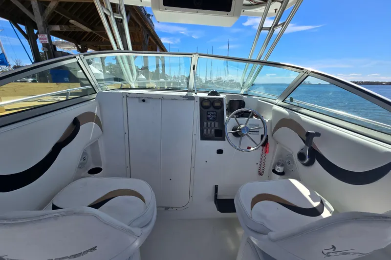 Slide: The Image of 2003 Seaswirl Striper 2301 Walkaround OB boat interior with steering wheel and seating. - 14