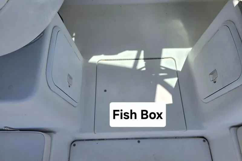 Slide: The Image of 2003 Seaswirl Striper 2301 Walkaround OB fish box compartment on deck. - 16