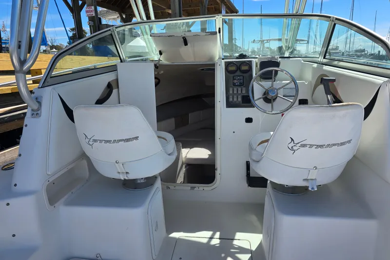 Slide: The Image of 2003 Seaswirl Striper 2301 Walkaround OB boat interior with steering wheel and seating. - 18
