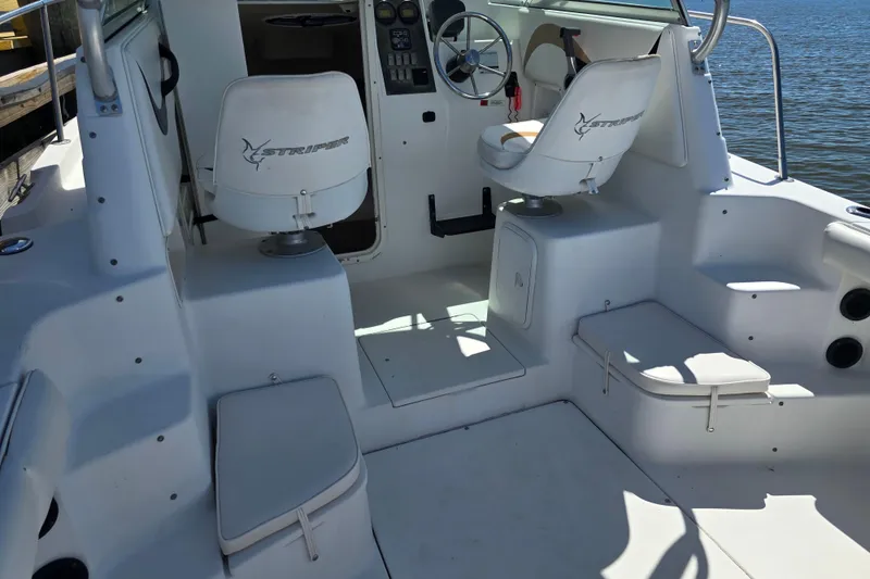 Slide: The Image of 2003 Seaswirl Striper 2301 Walkaround OB boat interior with seating and steering wheel. - 21
