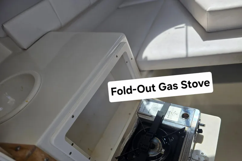 Slide: The Image of Fold-out gas stove on 2003 Seaswirl Striper 2301 Walkaround OB boat. - 23