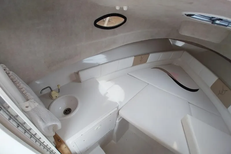 Slide: The Image of 2003 Seaswirl Striper 2301 Walkaround OB cabin interior with sink and seating area. - 27