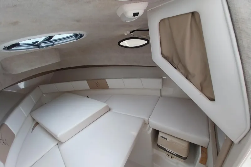 Slide: The Image of 2003 Seaswirl Striper 2301 Walkaround OB cabin interior with cushioned seating and storage. - 28