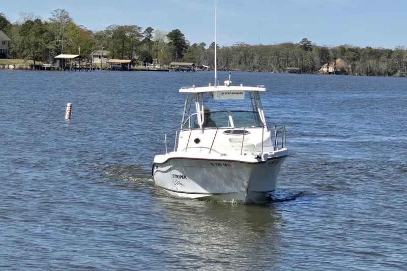 Slide: The Image of 2003 Seaswirl Striper 2301 Walkaround OB cruising on a serene lake. - 31