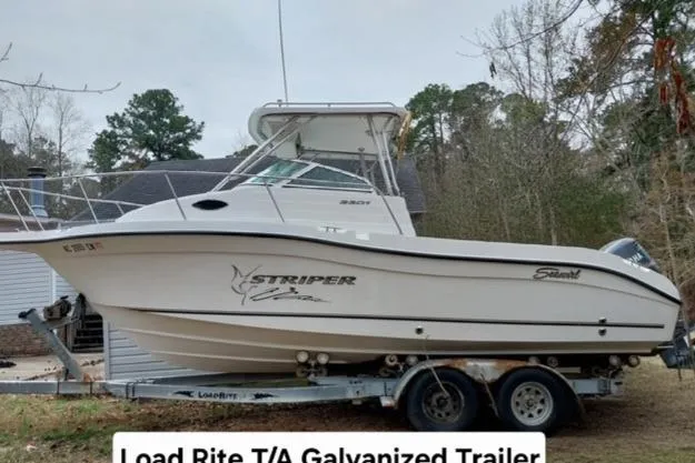 Slide: The Image of 2003 Seaswirl Striper 2301 Walkaround OB on Load Rite galvanized trailer, parked outdoors. - 5