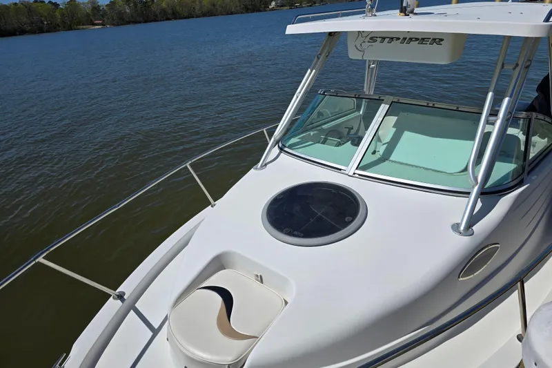 Slide: The Image of 2003 Seaswirl Striper 2301 Walkaround OB boat on calm lake waters. - 8