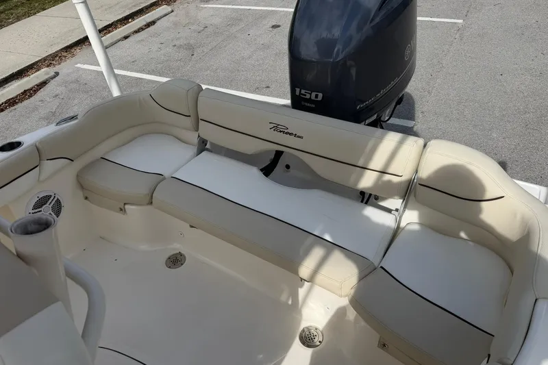 Slide: The Image of 2017 Pioneer 202 Islander boat interior with cushioned seating and Yamaha 150 outboard motor. - 12