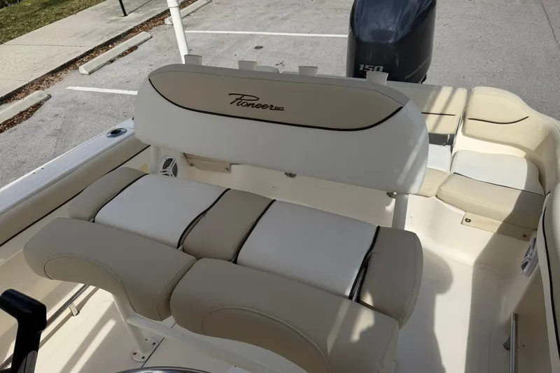 Slide: The Image of Interior view of a 2017 Pioneer 202 Islander boat with seating and motor. - 14