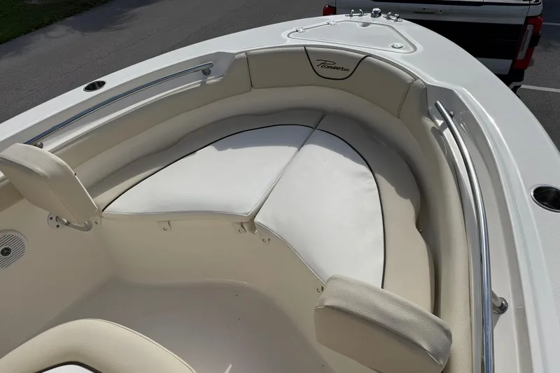 Slide: The Image of 2017 Pioneer 202 Islander boat interior with cushioned seating and stainless steel railings. - 19