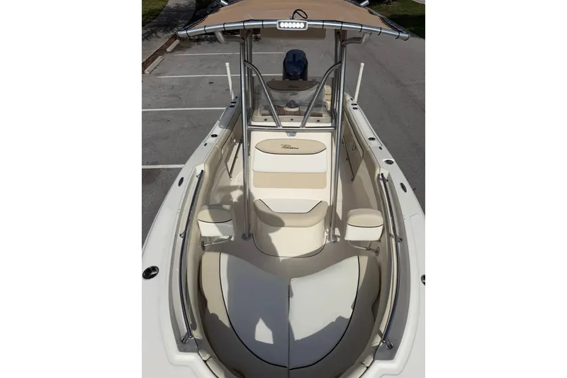 Slide: The Image of 2017 Pioneer 202 Islander boat with beige seating and canopy, parked in a lot. - 22