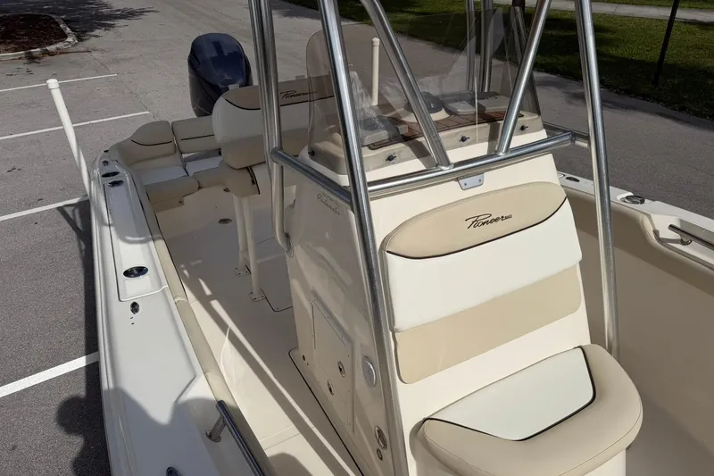 Slide: The Image of 2017 Pioneer 202 Islander boat with beige seating and stainless steel railings. - 23