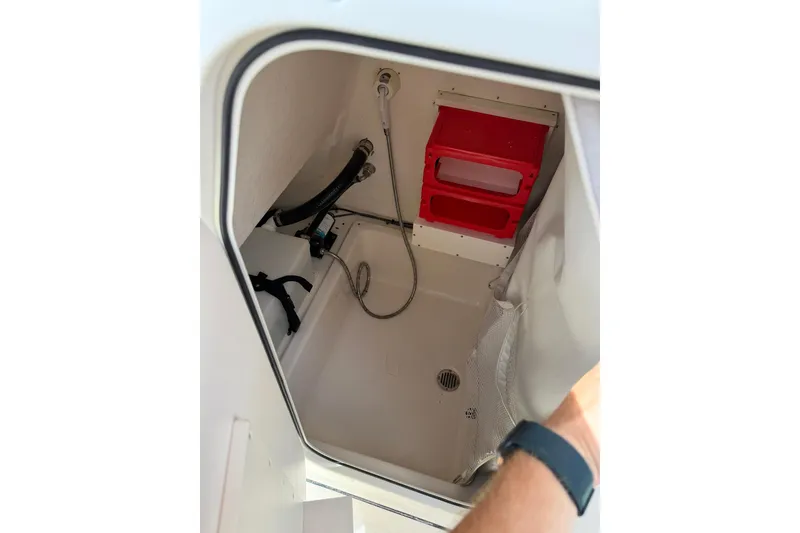 Slide: The Image of Interior storage compartment of a 2017 Pioneer 202 Islander boat with red shelving. - 24