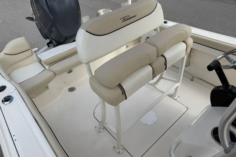 Slide: The Image of 2017 Pioneer 202 Islander boat interior with beige seating and Yamaha engine. - 25