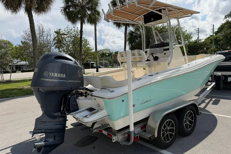 Slide: The Image of 2017 Pioneer 202 Islander boat with Yamaha engine on trailer, parked outdoors. - 3
