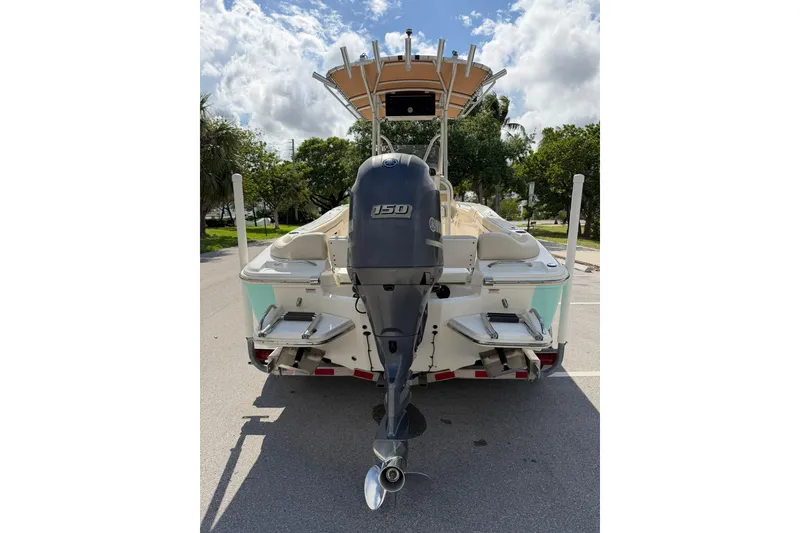 Slide: The Image of 2017 Pioneer 202 Islander boat with outboard motor, parked on a sunny day. - 4