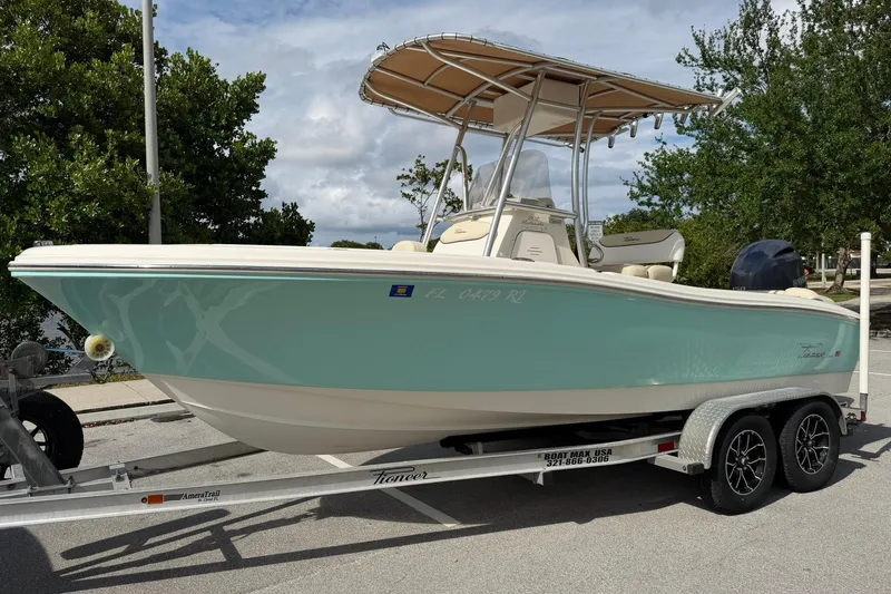 Slide: The Image of 2017 Pioneer 202 Islander boat on trailer, parked outdoors under cloudy sky. - 7
