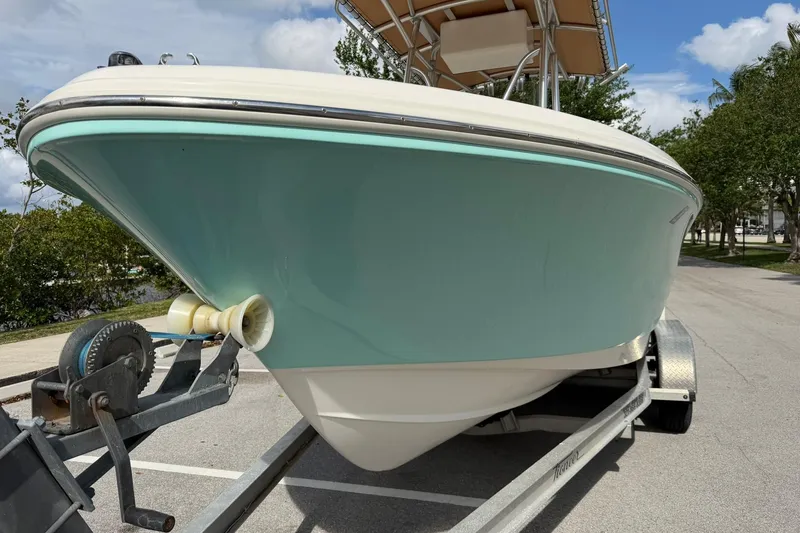 Slide: The Image of 2017 Pioneer 202 Islander boat on trailer, light blue hull, parked outdoors. - 8