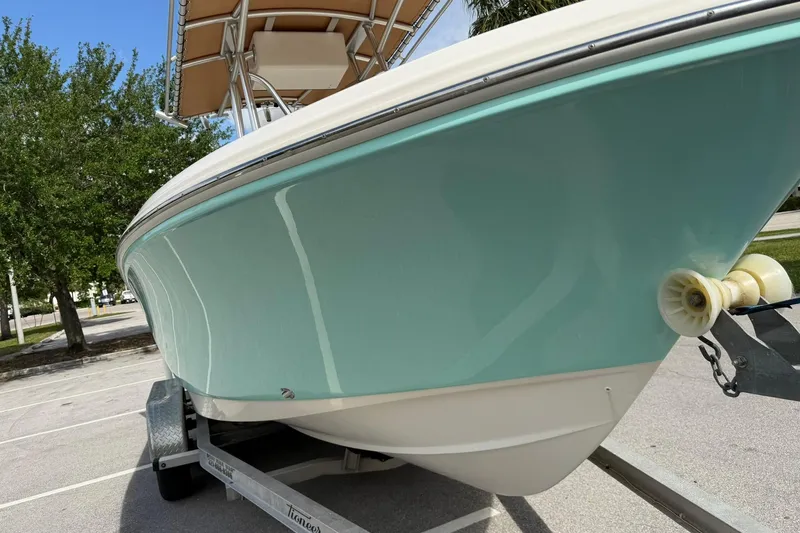 Slide: The Image of 2017 Pioneer 202 Islander boat on trailer, light blue hull, parked outdoors. - 9