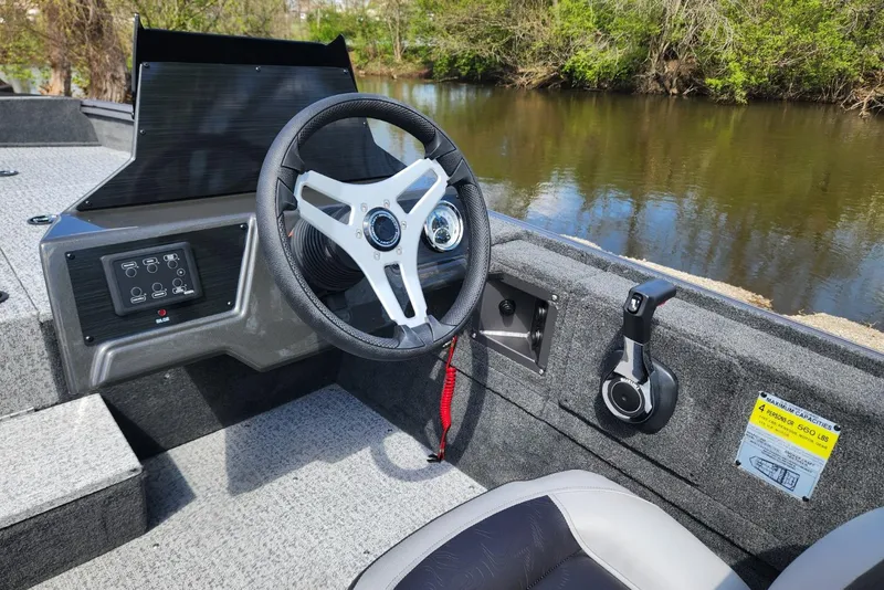 Slide: The Image of 2026 Smoker Craft Viper XR 175 Pro boat interior with steering wheel and control panel. - 14