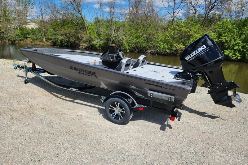 Slide: The Image of 2026 Smoker Craft Viper XR 175 Pro boat with Suzuki engine by a riverbank. - 4