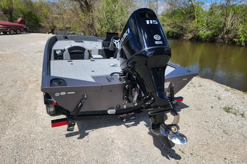 Slide: The Image of 2026 Smoker Craft Viper XR 175 Pro boat with Suzuki 115 engine by a river. - 5